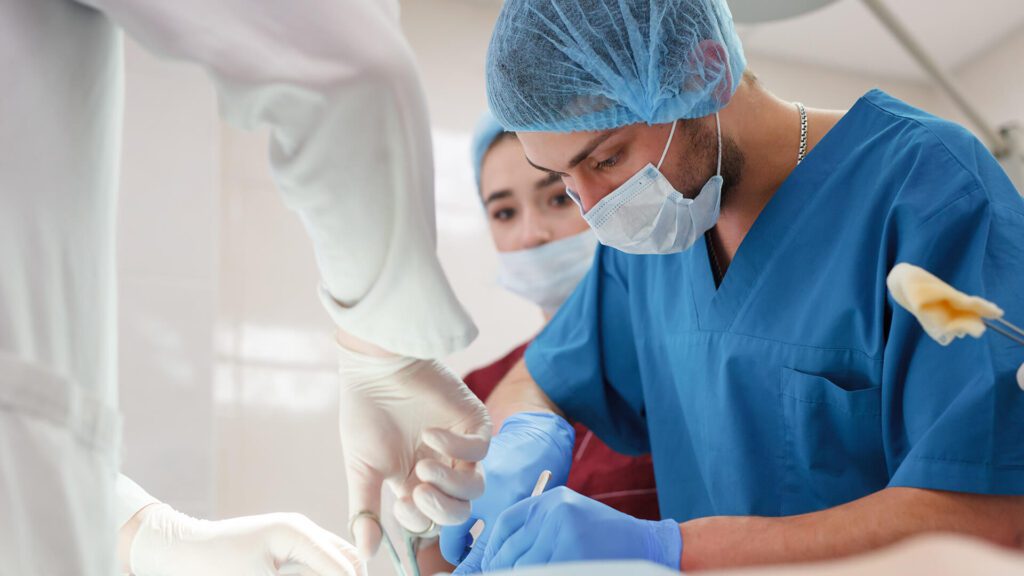 Surgeons performing a medical procedure together.