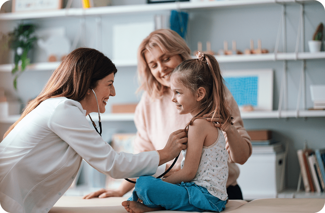 Doctor examining child with mother present.
