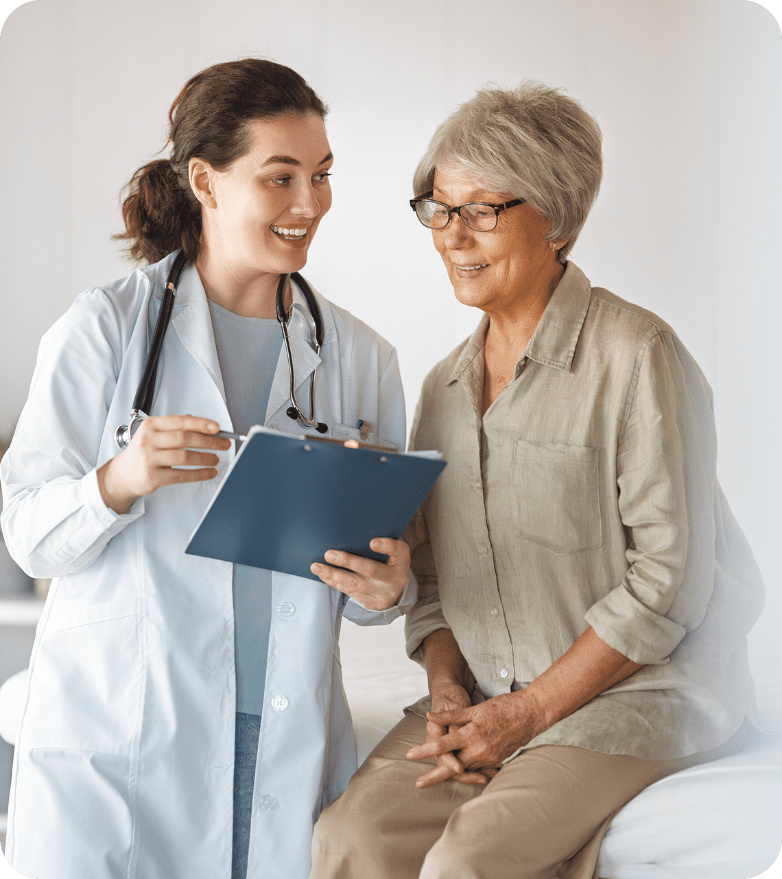 Doctor and elderly woman discussing medical notes.