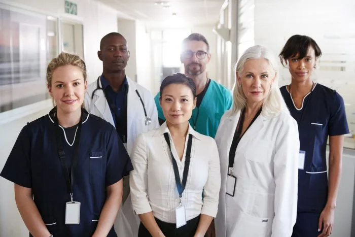 Medical team standing in a hospital corridor.