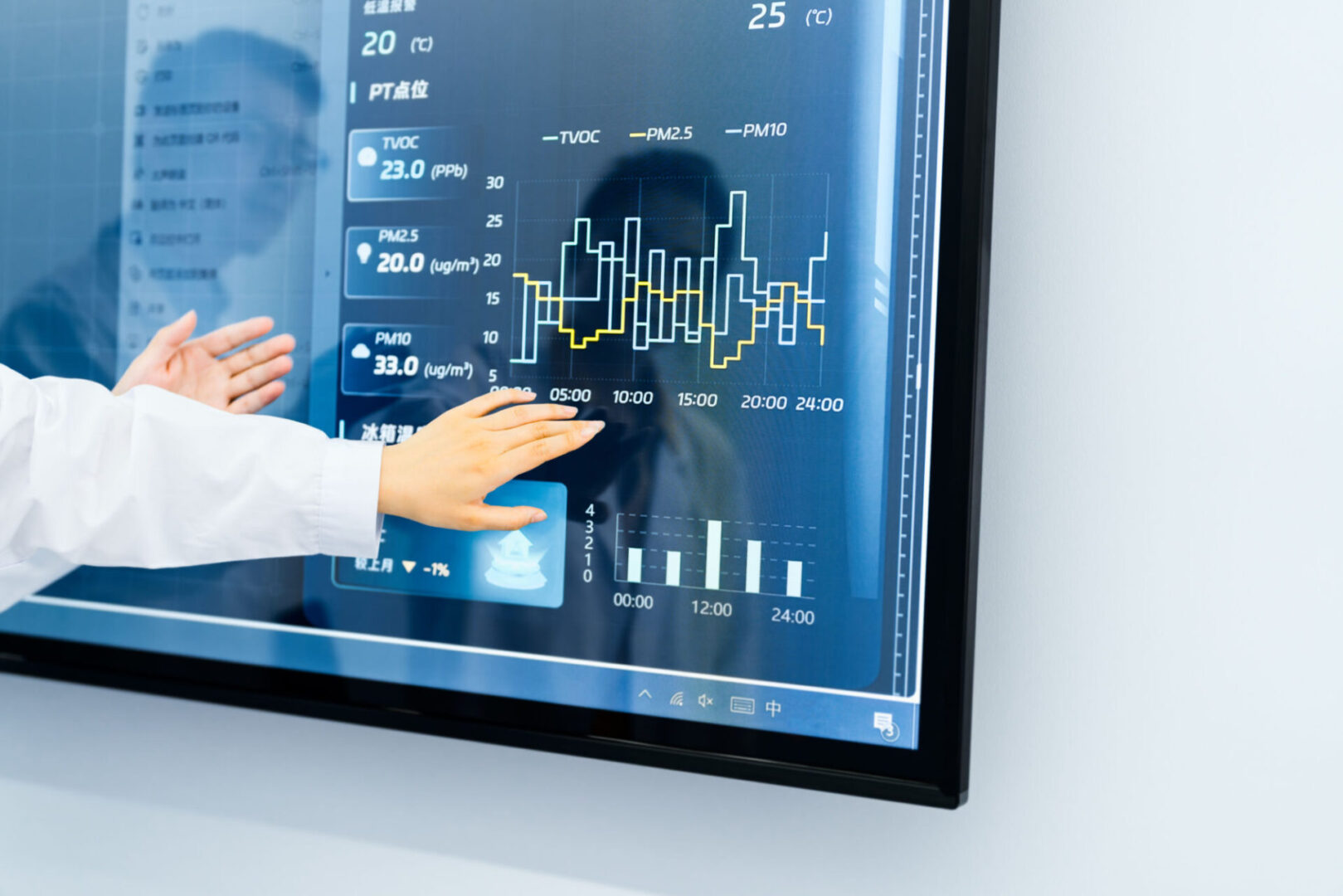 Person interacting with data on digital screen.